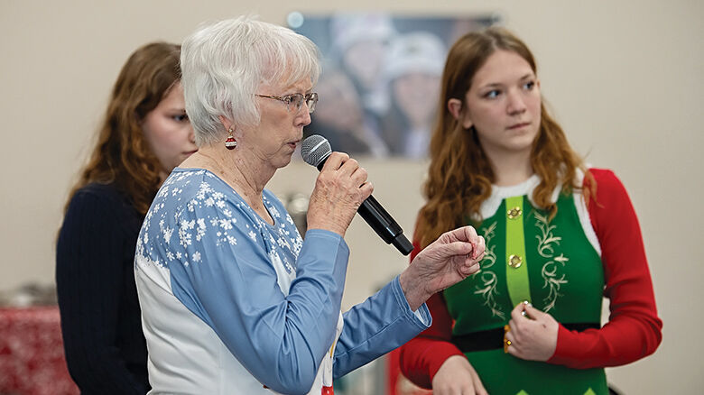Carole Yount calls out winning numbers for a bike raffle.