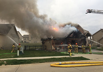 Rock firefighters work to put out a blaze that started in a garage at this home on Strawberry Ridge Drive in Arnold.
