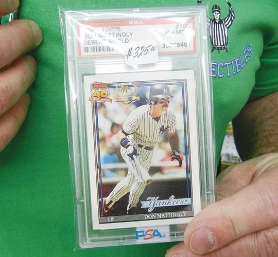 Ken holds a 1991 Topps baseball card with a special Desert Storm insignia.