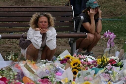 Mourners gather around floral tributes at the Bondi Pavilion in Sydney in memory of victims of the Bondi Beach shooting.