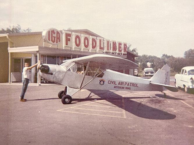 A civil air patrol plane parked at the IGA Foodliner grocery store once located at 225 Thresher Drive in the 1960s. The space now houses Lindell Bank.