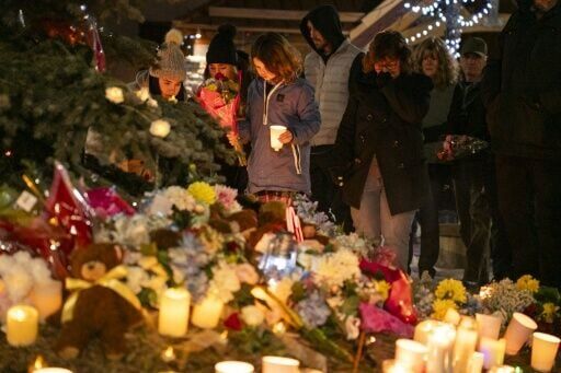 Community members mourn during a candlelight vigil for the victims of Tumbler Ridge Secondary School in British Columbia, Canada, where a rare mass shooting left eight dead along with the shooter