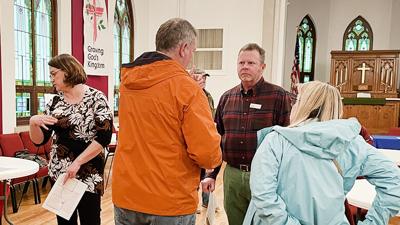 Missouri Department of Transportation area engineer Stephen O’Connor, center, listens to residents during an open house at St. John’s Lutheran Church.