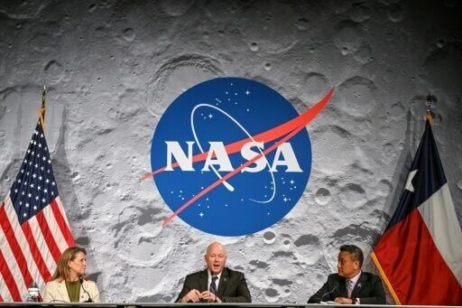 NASA officials Lori Glaze (L) and Howard Hu (R) listen to NASA flight director Judd Frieling speak during a status briefing of the Artemis II lunar mission at Johnson Space Center in Houston, Texas
