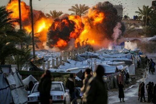 A fireball following an Israeli strike near a camp sheltering people displaced by war in Deir el-Balah, central Gaza