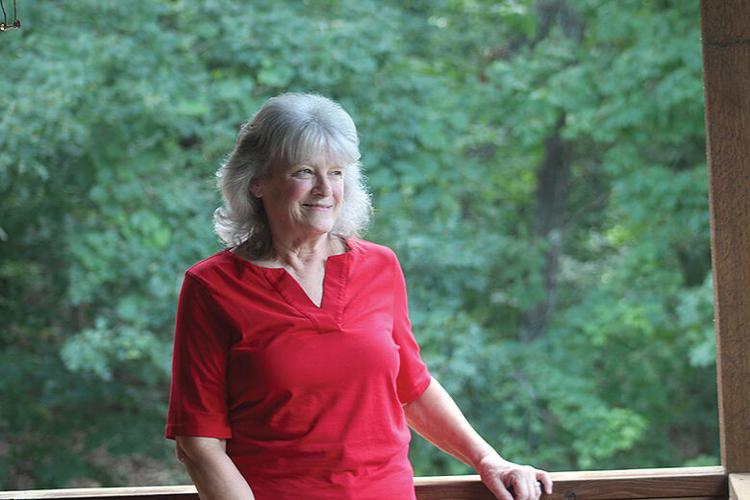 Lauri Harris poses in the house she and her husband, James, built 20 years ago  in Valles Mines.