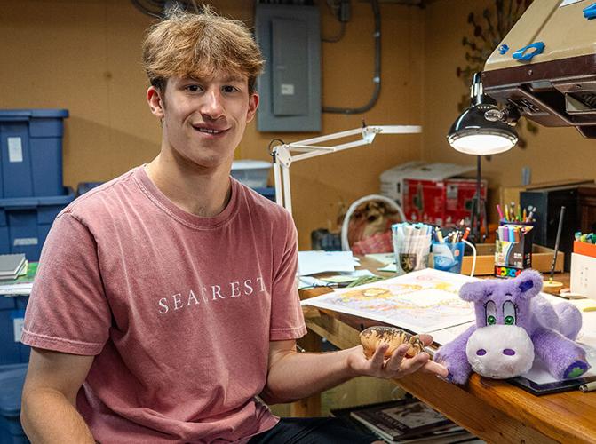 Connor Preston holds the original hippo (Ghub Ghub) that traveled on family trips.