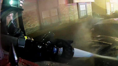 A Rock Community firefighters puts out a vehicle fire outside the Richardson Place Apartments.