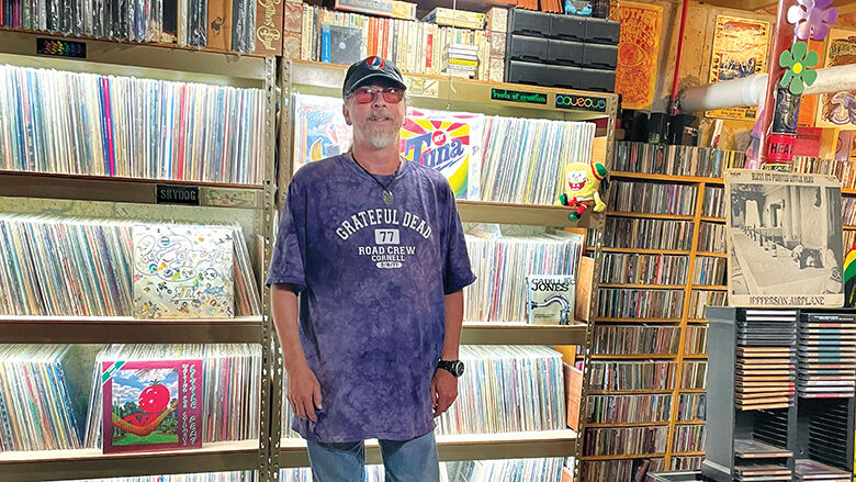 James Mullins, 53, of De Soto, stands in front of a section of his vast music collection.