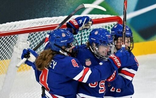 USA women's ice hockey forward Hayley Scamurra (centre) is mobbed by her teammates after scoring in their opening win against the Czech Republic