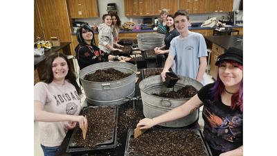 Northwest High School students create seed trays to grow wildflowers that they will plant in the community.