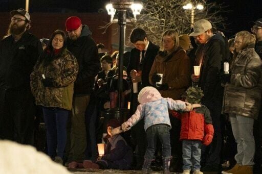 Community members mourn during a candlelight vigil for the victims of Tumbler Ridge Secondary School where a mass shooting killed five children and an educator