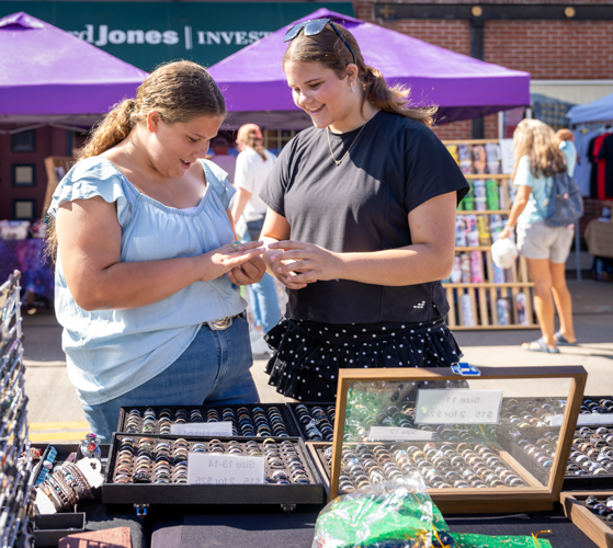 Sisters, from left, Madalyn Gray, 12, and Raelyn Gray, 13, of Festus look at rings on Festus Main Street during the Main Street Market.