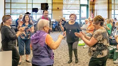 Expogoers dance to the music of J.B. Louis and the Legends during the 2021 Arnold Senior Expo.