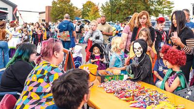 Poseidon Santonge, 7, of Imperial, dressed as a skeleton, is one of many children lined up for candy during the Jefferson College Community Trunk or Treat event.