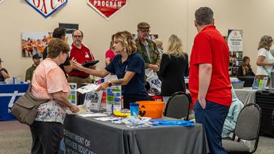 Candace Stokes picks up information from the Workforce Development booth.