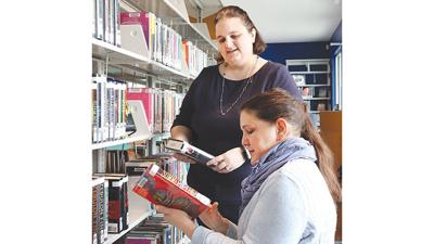 Library supervisor Karen Jones, back, and circulation clerk Holly Zacarias prepare for the grand opening of the Jefferson County Library’s Cedar Hill satellite, set for  11 a.m. to 1 p.m. on Monday, Feb. 20, at the satellite, 6780 Mall Drive, in Cedar H...