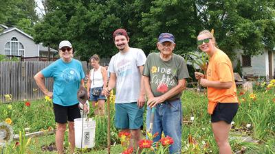 Carrol Wrather, 90, of Kimmswick helps get lilies for customer Robin Blake, at left, of Hillsboro with help from his great-grandchildren, Austin Maiden, 26, and Riley Fendler, 20.