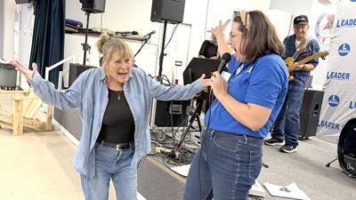 Mona Asinger, left, of Barnhart is announced as the grand prize winner by Leader advertising manager Katelyn Mary Skaggs on Aug. 19 near the end of the Arnold Senior Expo at the Arnold Eagles Hall.