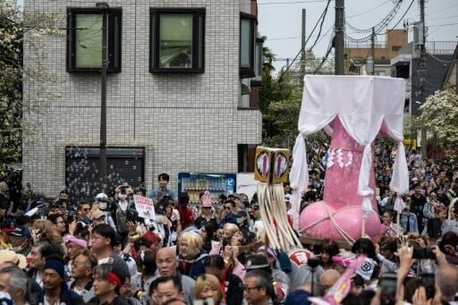 Showcasing phallus-shaped portable shrines and pink penis candies, Japan's annual fertility festival teemed with tourists, couples and families