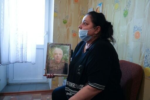 Iryna Levchikov, Bogdan's mother -- who has cancer -- holds a photo of her husband Stanislav, who was killed defending Kharkiv