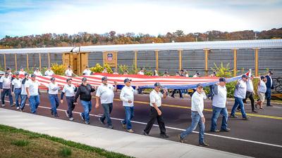 A large American flag is carried during last year’s De Soto Veterans Day Parade.