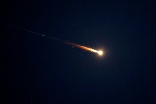 Rocket trails are seen in the sky above Netanya, in central Israel, amid a fresh barrage of Iranian missile attacks