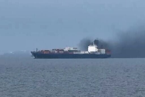 This image, taken from video footage shot by seafarer Wang Shang on Thursday, shows smoke billowing from a cargo vessel in the Gulf