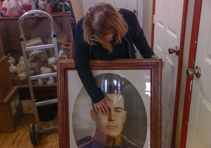 Jackeline King looks down at a portrait of her grandfather