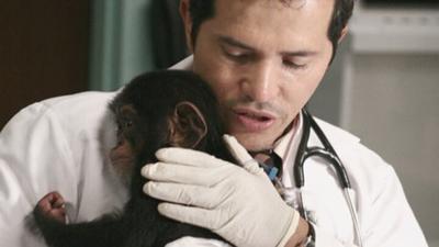 Actor John Leguizamo, playing Dr. Victor Clemente in "ER", holds Kenzy after filming a scene for the television show.