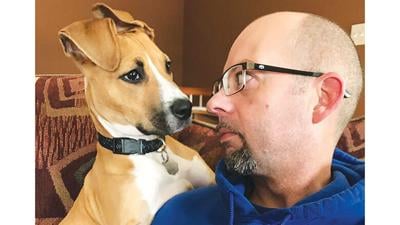 Bentley and owner Kenny Noel of Hillsboro cuddle together.