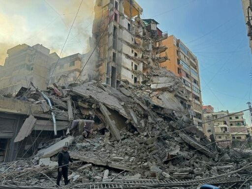 A man inspects the debris of destroyed buildings at the site of an Israeli airstrike that targeted Haret Hreik neighbourhood in Beirut's southern suburbs on March 7
