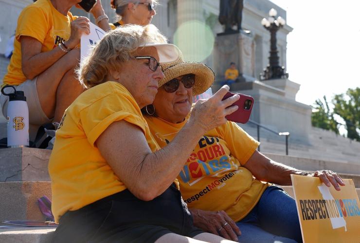 Sandy Terrell, left, and Vicki Fitzwilliam watch the livestream