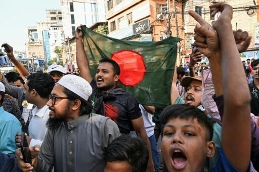 People in Dhaka celebrate the court's verdict after fugitive former prime minister Sheikh Hasina was found guilty and sentenced to death