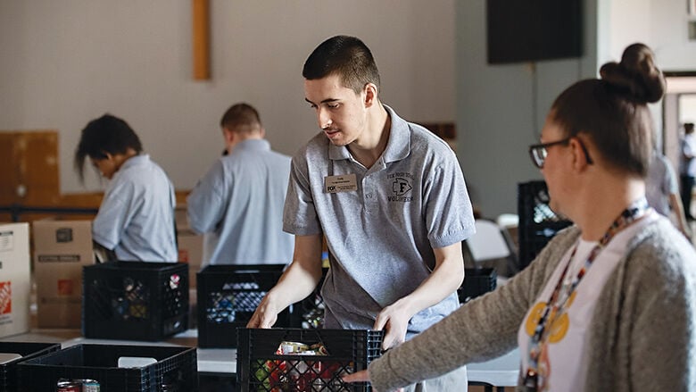 Cody Boyer of Fox High School volunteers at the Arnold Salvation Army on March 11.