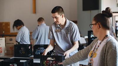 Cody Boyer of Fox High School volunteers at the Arnold Salvation Army on March 11.