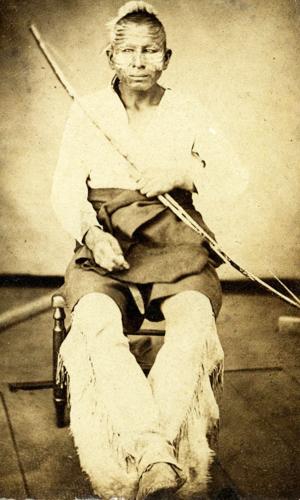 Photograph of Osage warrior in traditional dress.
