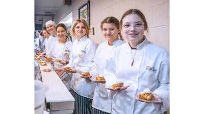 Students prepare to serve dessert at the 2023 Leader Holiday Dinner.