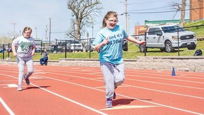 Sydney Parmley of De Soto, left, and Summer Miller of Pevely compete in the 50-meter race.
