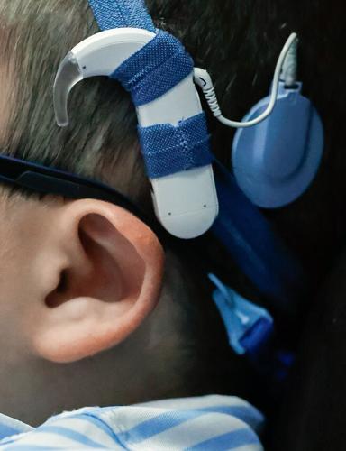 Carter wears cochlear implants while taking a break in a multi-sensory