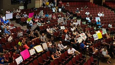 People against a mask requirement at the Fox C-6 School District showed up with signs for Tuesday's Board of Education meeting.