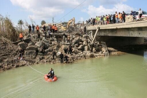 Lebanese rescuers personnel search for missing people in the river beneath the bomb-damaged Qasmiyeh bridge near the southern city of Tyre