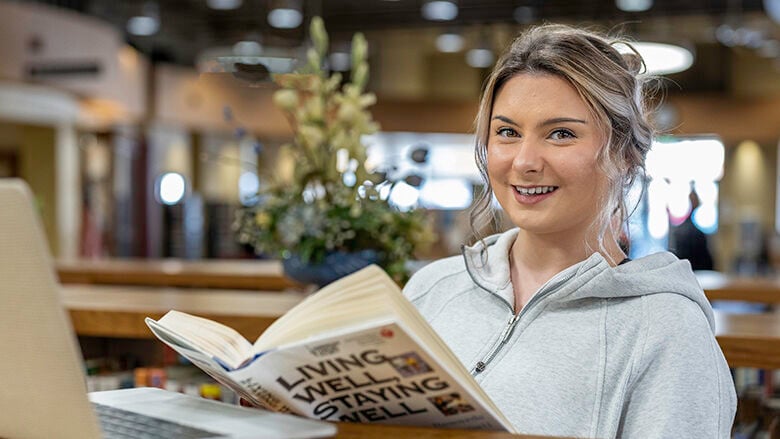 Maggie Holmes of Crystal City reads a health book at the Festus Public Library.