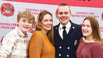 Melissa and Kyle Schnable with their children, Kolby, left, and Makenna at a recent pinning ceremony at the Antonia Firehouse.