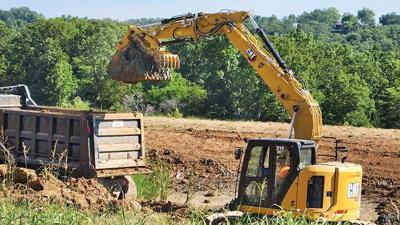 Excavators widen and deepen the stormwater retention pond, Freddie's Pond.