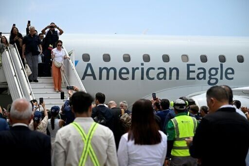 Passengers including US and Venezuelan officials disembark in Caracas as the two countries pursue a warming of relations