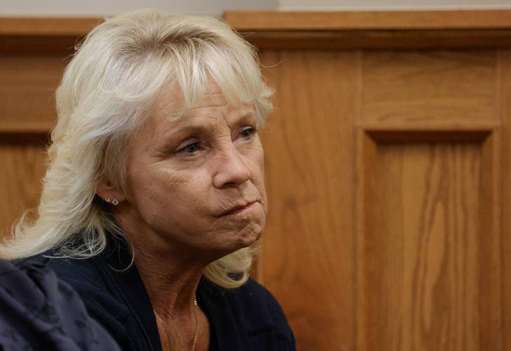 Stacy Perkins listens as instructions for the jury are read