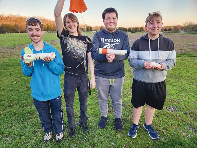Festus team members senior Cohen Trupiano, senior Matthew Vaughn, junior Tyler Trost and junior Owen Zinn holding their rocket after submitting their qualification flights.