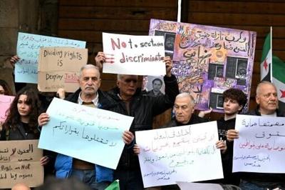 Syrians hold a silent protest against an official decision banning the sale of alcohol outside of certain areas