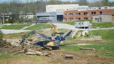 Workers prepare the site of the Festus R-6 gym project behind Festus High School.